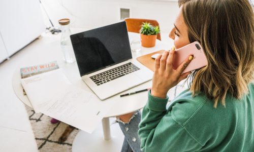 business-woman-at-her-desk-in-a-bright-minimalist-office-taking-a-phone-call_t20_QzB6gb